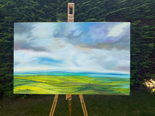 Peace original oil landscape painting of rolling green fields under a moody, dramatic grey and purple storm sky by Caroline Manson