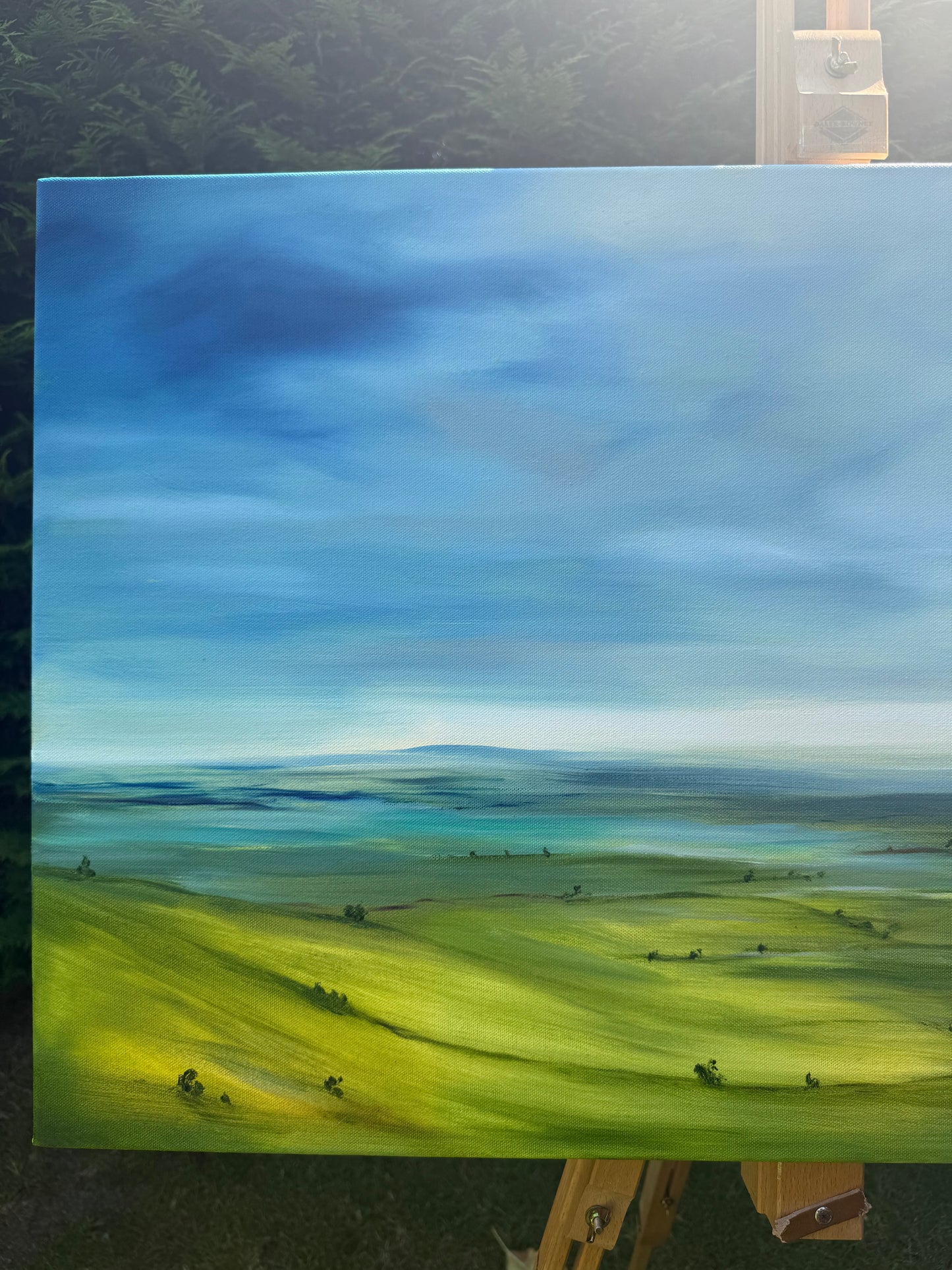 Breathe original oil landscape painting of rolling green hills under a dramatic blue and white sky by Caroline Manson