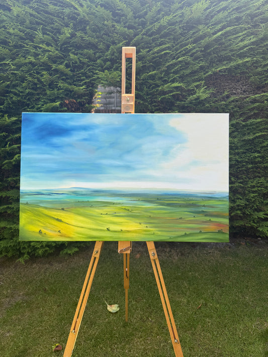 Breathe original oil landscape painting of rolling green hills under a dramatic blue and white sky by Caroline Manson