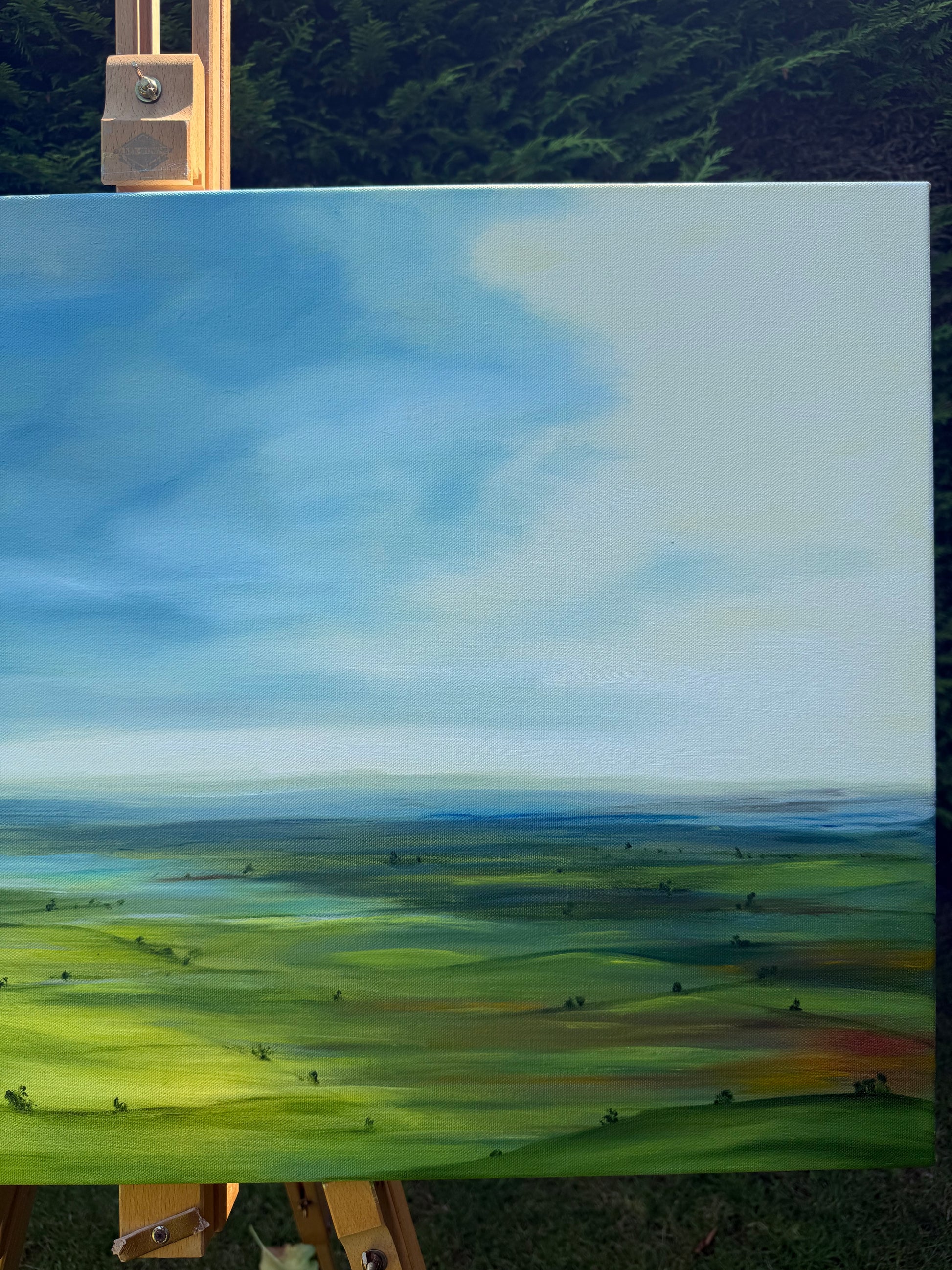 Breathe original oil landscape painting of rolling green hills under a dramatic blue and white sky by Caroline Manson